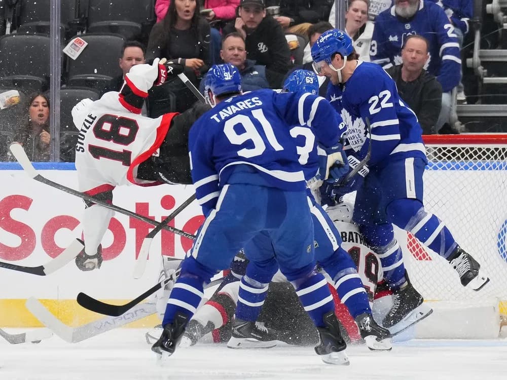 Maple Leafs and Senators battle for the puck